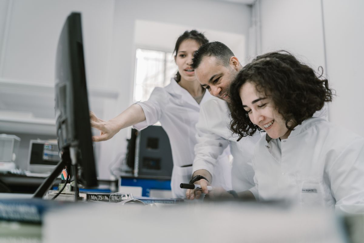 Researchers reviewing laboratory data together on a computer